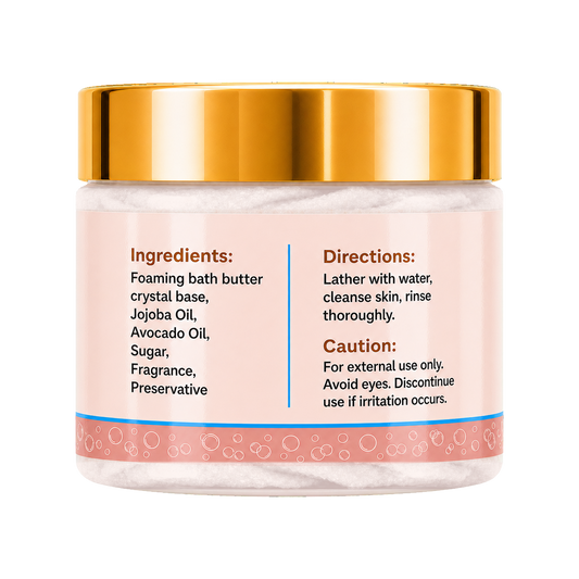 A jar of foaming bath butter with a shiny gold lid and a light pink label showing ingredients and directions, set against a plain white background.