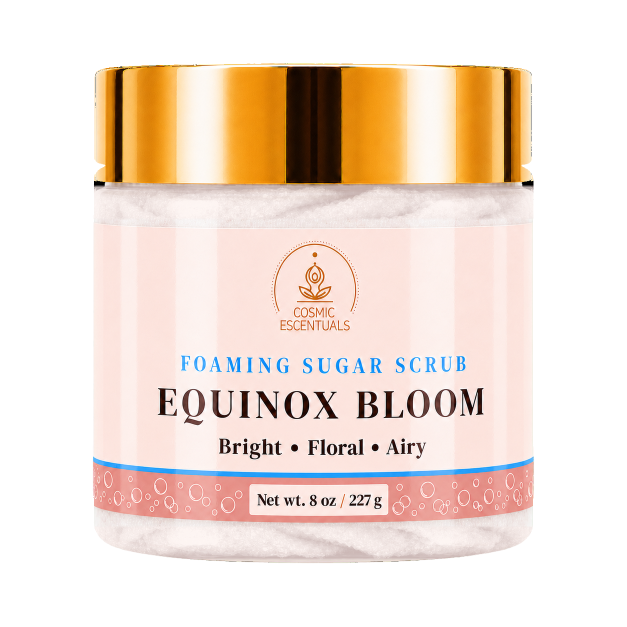 Cosmic Essentials Equinox Bloom Foaming Sugar Scrub in a clear jar with a metallic gold lid and a light pink label, set against a plain white background.