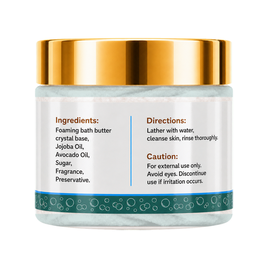 A jar of foaming bath butter with a shiny gold lid and a white label featuring product ingredients and usage directions, set against a plain white background.
