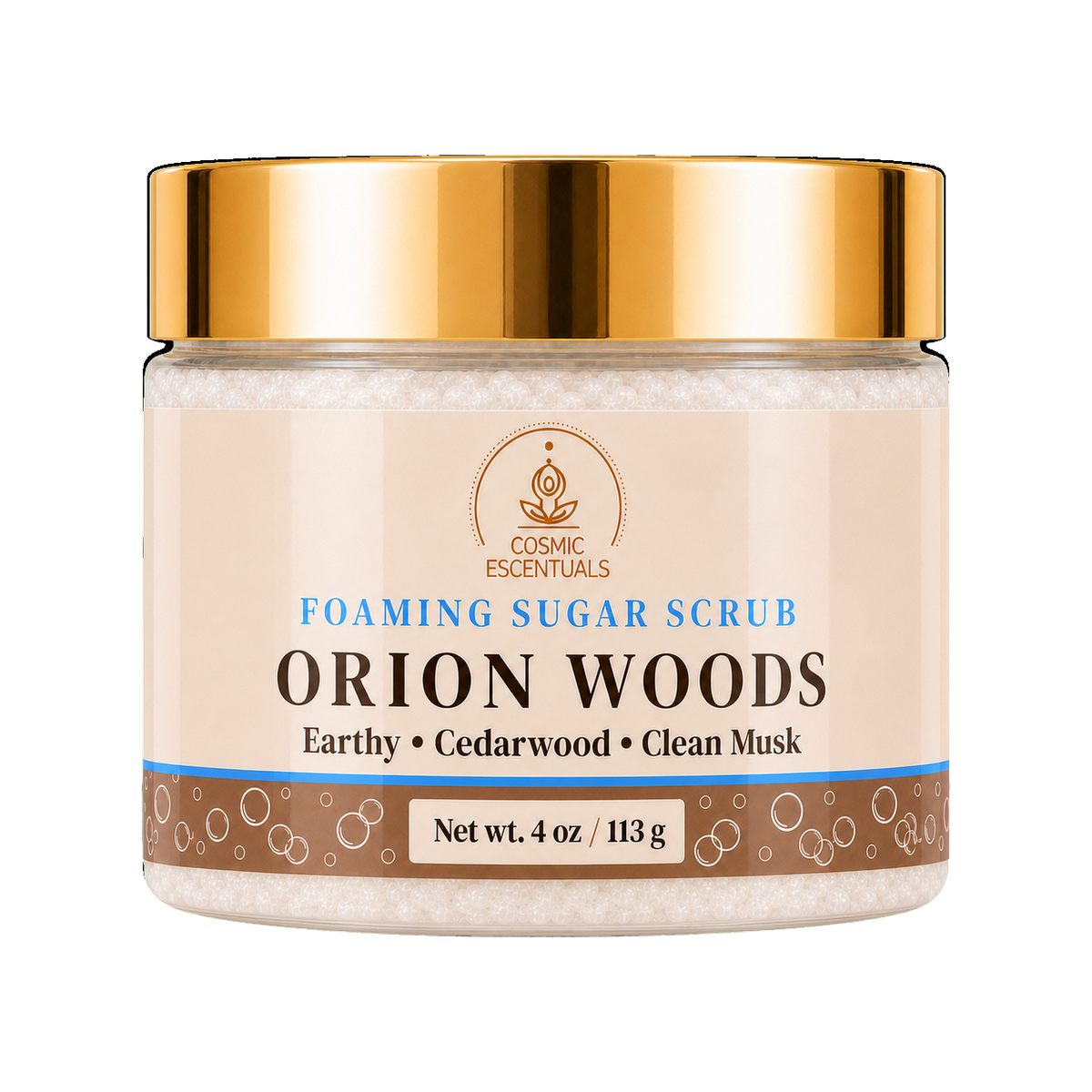 Cosmic Escentuals Orion Woods Foaming Sugar Scrub, 4oz jar with a shiny gold lid and a beige label, on a plain white background.