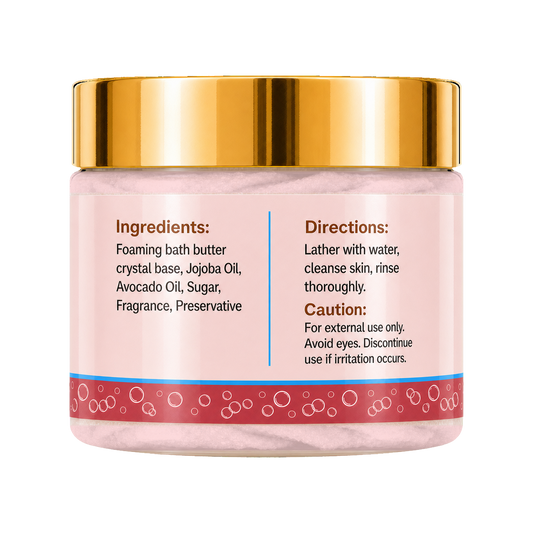 A jar of foaming bath butter with a shiny gold lid and a pink label showing the ingredients and directions, set against a plain white background.