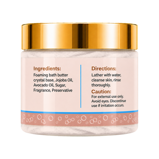 A jar of foaming bath butter with a shiny gold lid and a pale pink label showing ingredients and directions, set against a plain white background.