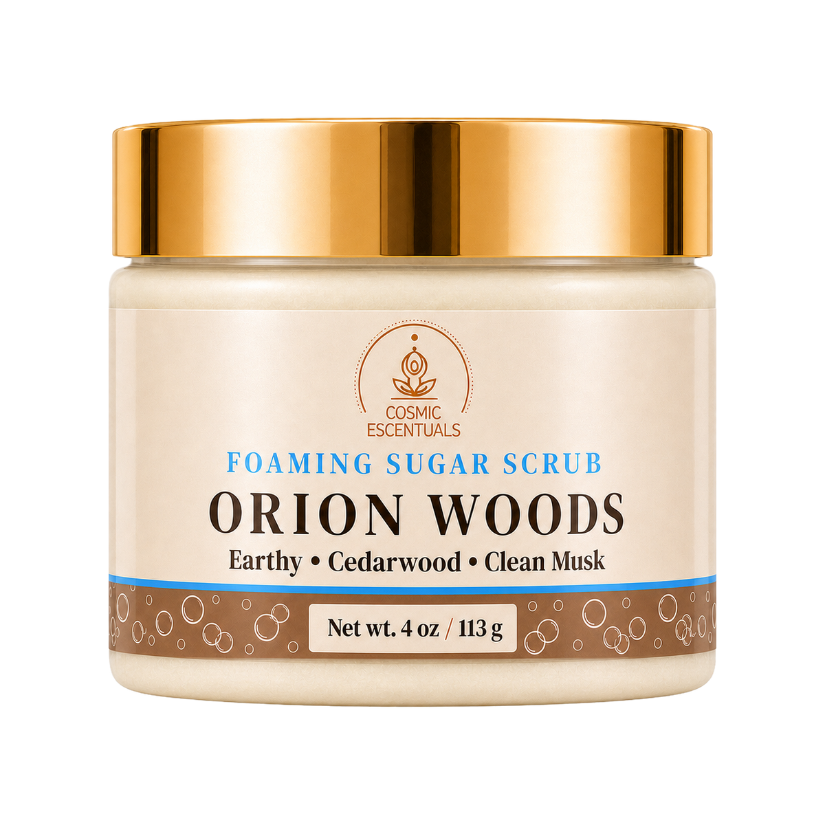 Cosmic Essentials Orion Woods Foaming Sugar Scrub in a 4 oz jar with a cream-colored label, a metallic gold lid, and a brown and blue decorative base band.