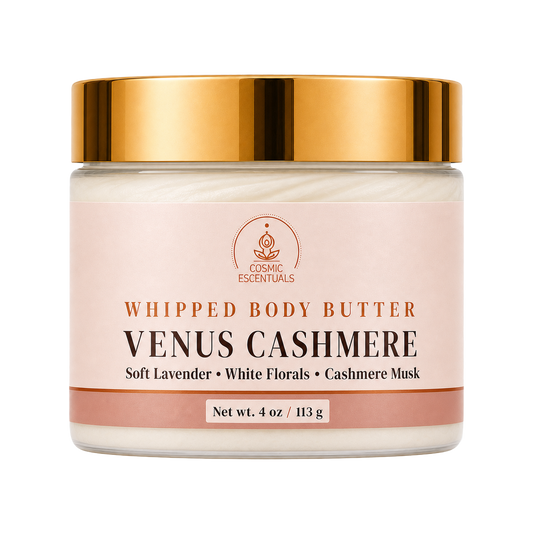 Cosmic Essentials Venus Cashmere Whipped Body Butter in a clear jar with a reflective gold lid and a pale pink label, shown on a solid white background.