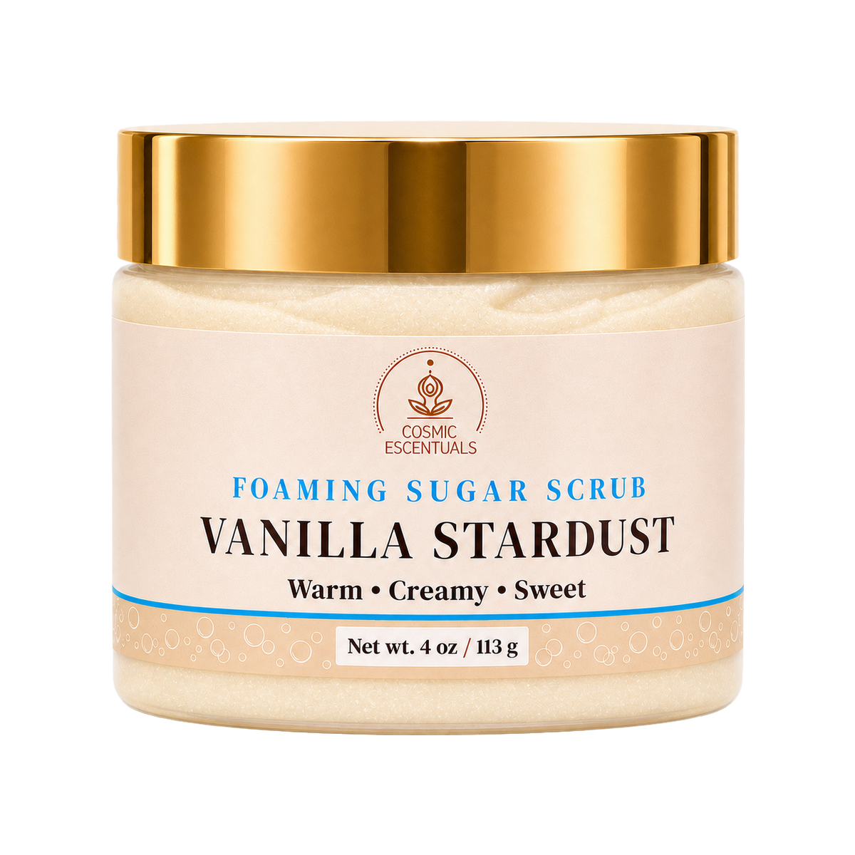 A jar of Vanilla Stardust Foaming Sugar Scrub by Cosmic Escentuals, featuring a warm cream-colored scrub inside, a metallic gold lid, and a beige label with blue and black text.