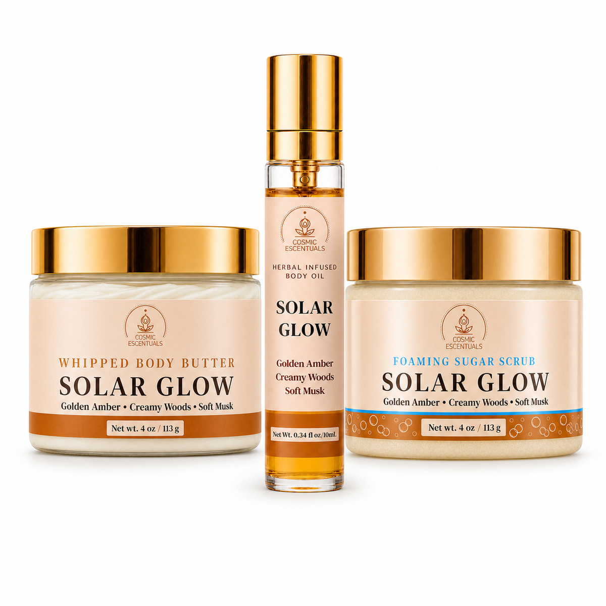 Cosmic Escentuals Solar Glow body care products on a white background: a Whipped Body Butter jar, a Foaming Sugar Scrub jar, and a Herbal Infused body oil spray bottle.