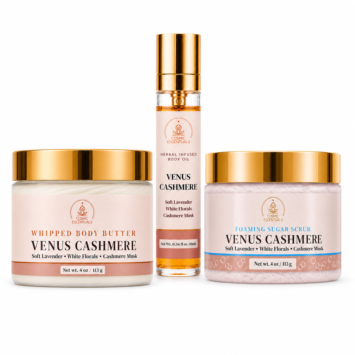 Three luxury skincare products from Venus Cashmere by Cosmic Escentuals arranged on a white background: a whipped body butter jar, a rose gold-toned spray bottle, and a foaming sugar scrub jar.