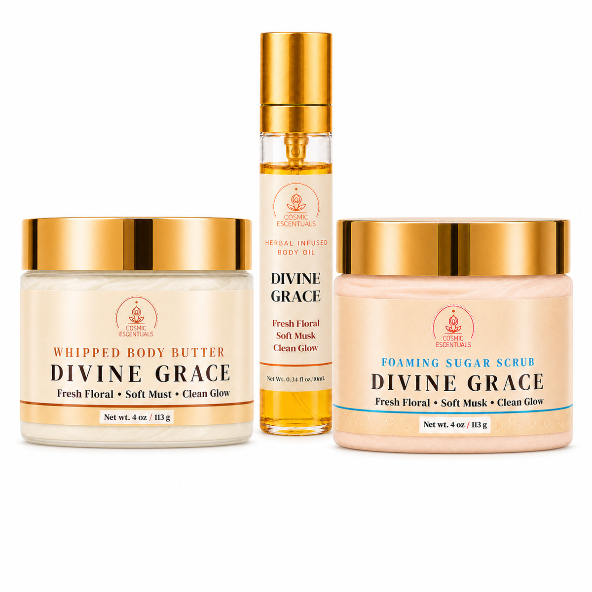 Three Divine Grace skincare products from Cosmic Escentuals arranged on a white background: a whipped body butter jar, a soft mask oil bottle, and a foaming sugar scrub jar.