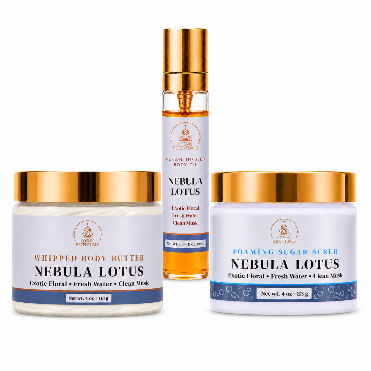 Three skincare products from Cosmic Escentuals arranged on a white background: a whipped body butter jar, a body oil spray bottle, and a foaming sugar scrub jar, all labeled Nebula Lotus with gold caps and blue-and-white labels.
