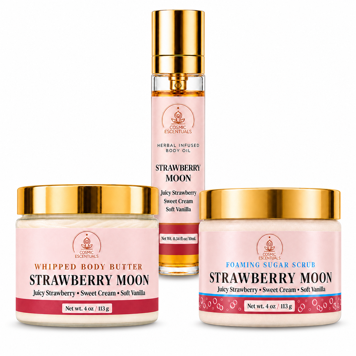 Three cosmetic products from Cosmic Escentuals on a white background: a bottle of Strawberry Moon Herbal Infused Body Oil, a 4 oz jar of Whipped Body Butter, and a 4 oz jar of Foaming Sugar Scrub. The products feature pink labels with gold lids.