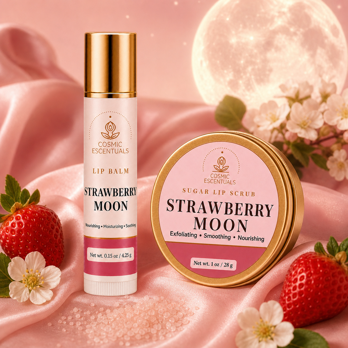 Two cosmetic products from Cosmic Escentuals, 'Strawberry Moon' lip balm and 'Sugar Lip Scrub' in a round tin, styled on pink satin with strawberries and white blossoms under a soft moon backdrop.