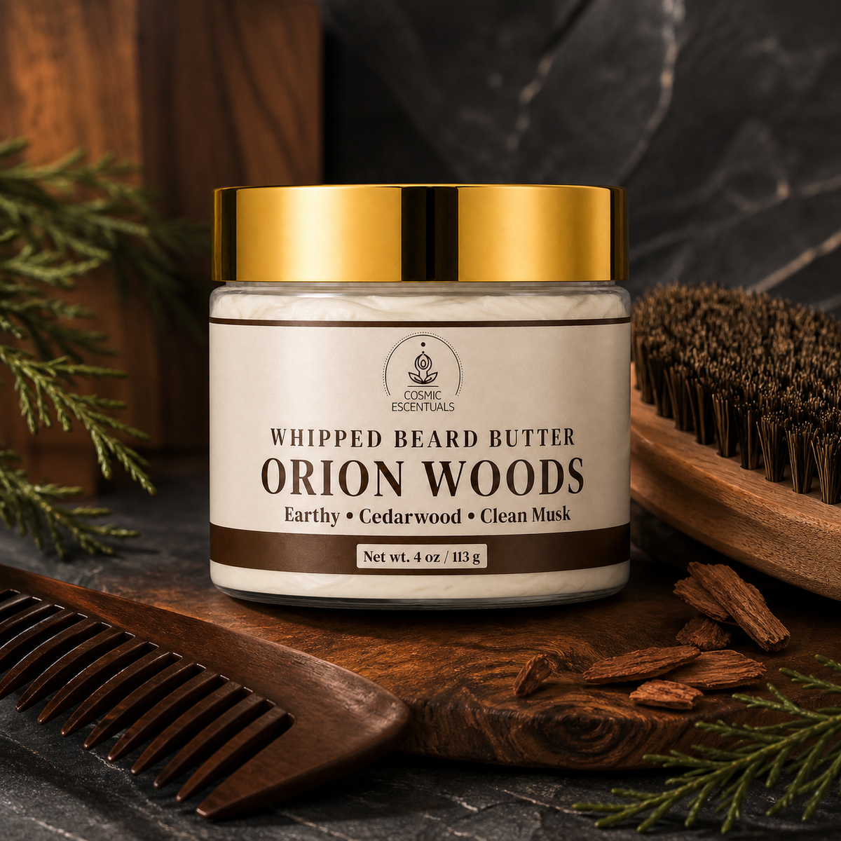 A jar of Cosmic Escentuals Whipped Beard Butter in the Orion Woods scent, styled on a dark stone surface with a wooden comb, beard brush, cinnamon sticks, and pine needles.