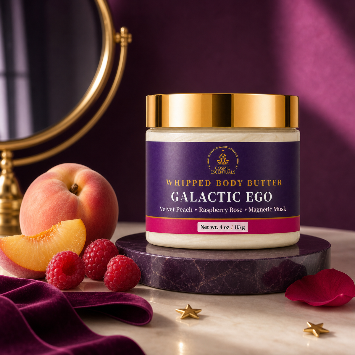 A jar of Cosmic Escentuals Whipped Body Butter in the Galactic Ego scent, styled on a marble pedestal with peaches, raspberries, a purple velvet cloth, and a gold mirror in the background.