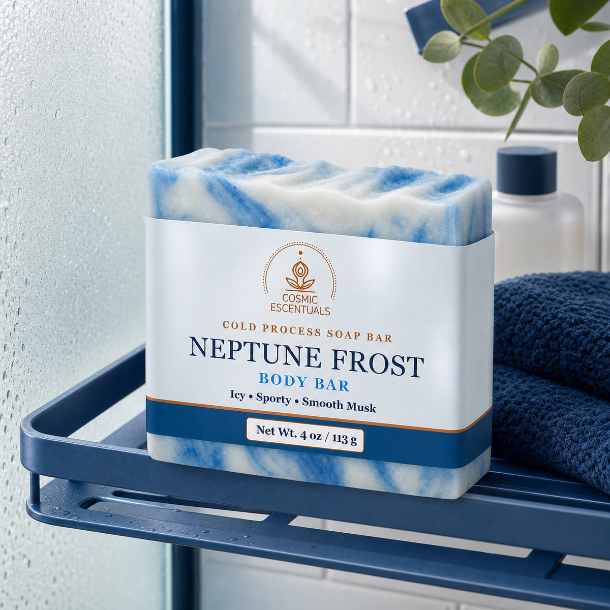 Neptune Frost Body Bar, marbled blue and white, on a navy shower caddy with a folded navy towel and eucalyptus against fogged glass.
