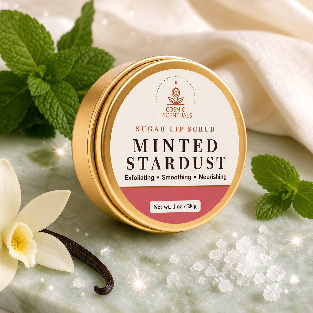 Minted Stardust Sugar Lip Scrub in its gold tin on a pale green stone surface, styled with fresh mint, a vanilla flower, vanilla pods and sugar crystals.