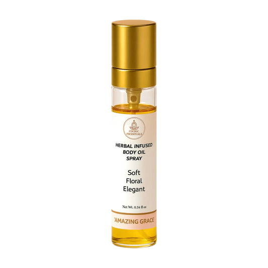 Herbal infused body oil spray bottle with gold cap on a white background