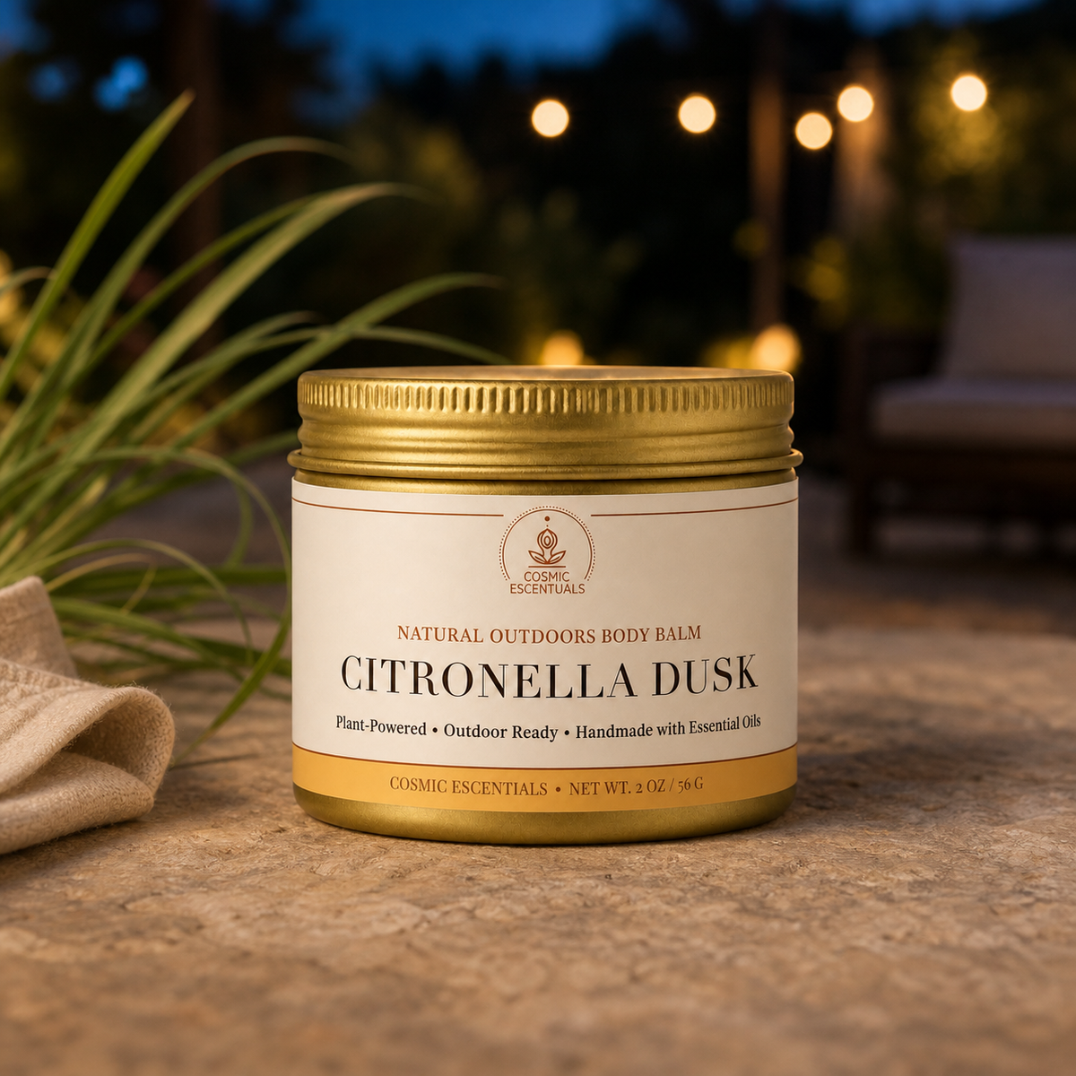 A jar of Cosmic Escentuals Citronella Dusk body balm sits on a stone surface outdoors at dusk, with warm string lights blurred in the background and greenery on the left.