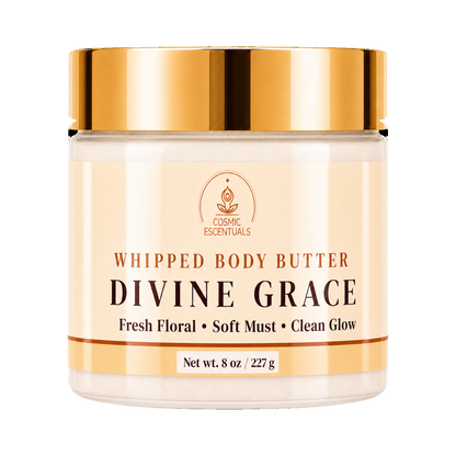 A jar of Divine Grace Whipped Body Butter by Cosmic Essentials, featuring a cream-colored body butter visible through the clear jar, a metallic gold lid, and a beige label with gold and black text.