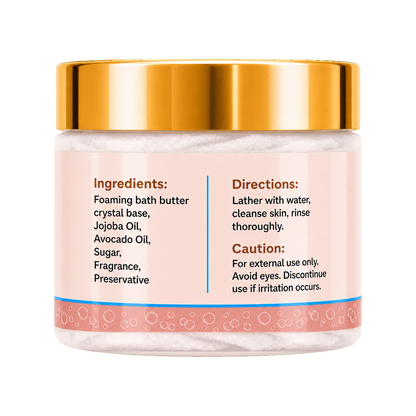 A jar of foaming bath butter with a shiny gold lid and a light pink label showing ingredients and directions, set against a plain white background.