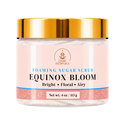 Cosmic Essentials Equinox Sugar Scrub in a clear jar with a metallic gold lid and a light pink label, set against a plain white background.
