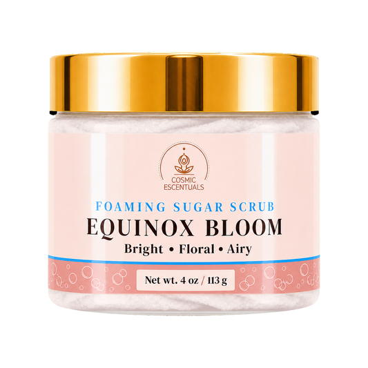 Cosmic Essentials Equinox Sugar Scrub in a clear jar with a metallic gold lid and a light pink label, set against a plain white background.