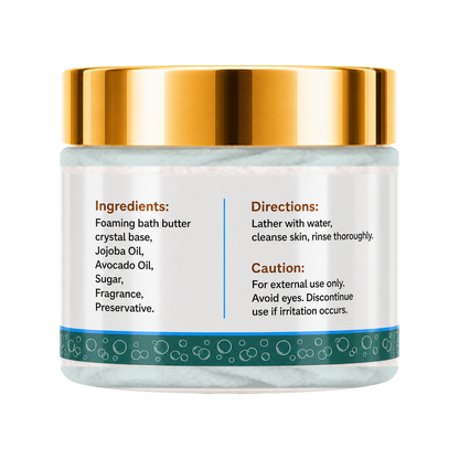 A jar of foaming bath butter with a shiny gold lid and a white label featuring product ingredients and usage directions, set against a plain white background.