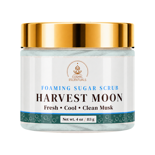 Cosmic Essentials Harvest Moon Foaming Sugar Scrub in a 4 oz jar with a shiny gold lid and a white label featuring blue and black text.