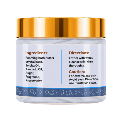 A jar of foaming bath butter with a shiny gold lid and a white label featuring blue accents and product instructions.