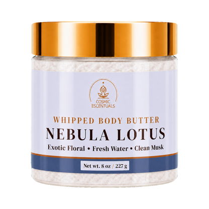 Cosmic Essentials Whipped Body Butter in Nebula Lotus scent, in a clear jar with a metallic gold lid and a light lavender label, containing white whipped body butter.
