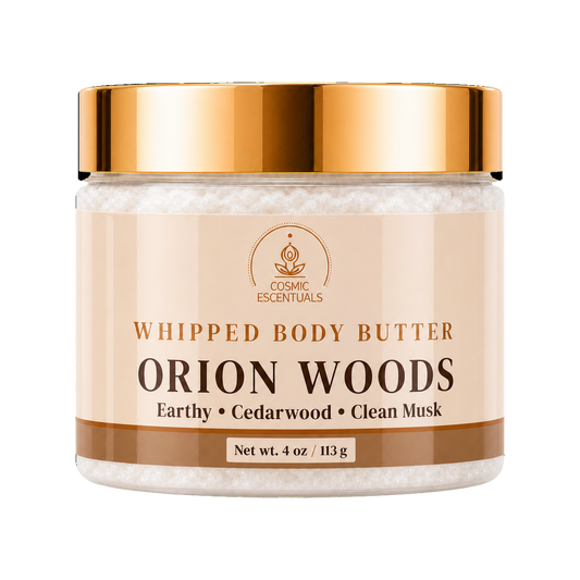 Cosmic Escentuals Orion Woods Whipped Body Butter, 4oz jar with a shiny gold lid and a beige label, on a plain white background.