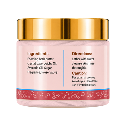 A jar of foaming bath butter with a shiny gold lid and a pink label showing the ingredients and directions, set against a plain white background.