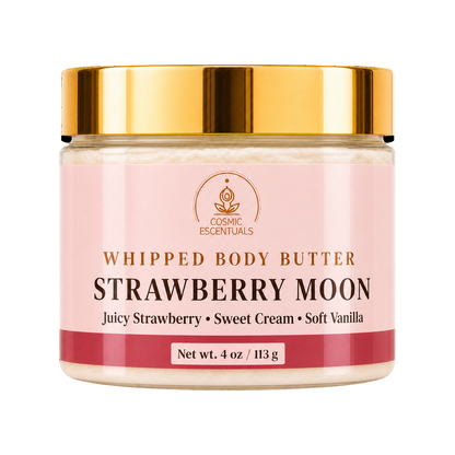 A jar of Cosmic Essentials Whipped Body Butter, Strawberry Moon, featuring a light pink label with gold lettering and a shiny gold metallic lid, set against a plain white background.