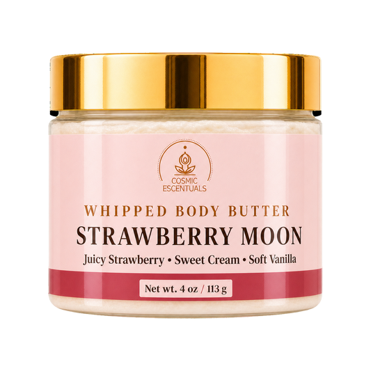 A jar of Cosmic Essentials Whipped Body Butter, Strawberry Moon, featuring a light pink label with gold lettering and a shiny gold metallic lid, set against a plain white background.
