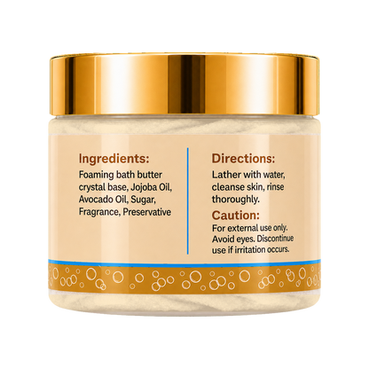 A jar of foaming bath butter with a shiny gold lid and a beige label showing product instructions and ingredients, set against a plain white background.