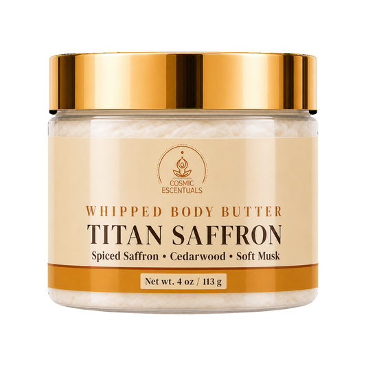 A jar of Cosmic Essentials Titan Saffron Whipped Body Butter with a shiny gold lid and a beige label, set against a plain white background.
