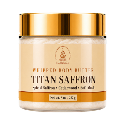 A jar of Cosmic Essentials Titan Saffron Whipped Body Butter with a shiny gold lid and a beige label, shown on a solid white background.