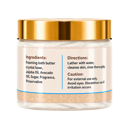 Foaming bath butter in a clear jar with a metallic gold lid and a beige label containing product instructions and ingredients.