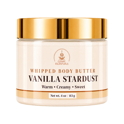 Cosmic Essentials Vanilla Stardust Whipped Body Butter in a clear jar with a shiny gold lid and cream-colored label, set against a plain white background.