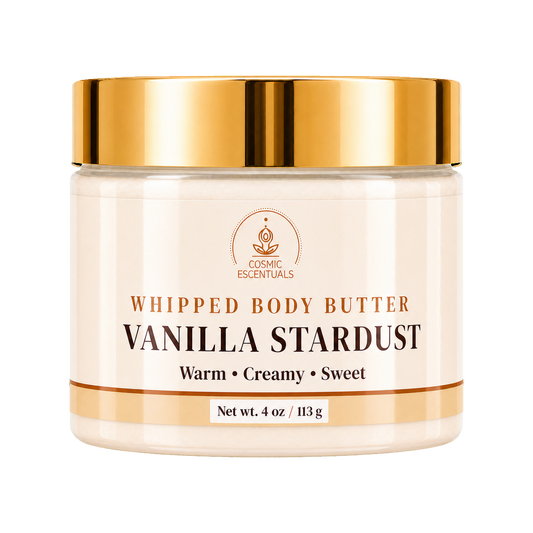 Cosmic Essentials Vanilla Stardust Whipped Body Butter in a clear jar with a shiny gold lid and cream-colored label, set against a plain white background.