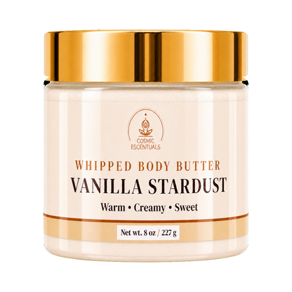 A jar of Cosmic Essentials Whipped Body Butter in Vanilla Stardust scent, featuring a metallic gold lid and a cream-colored label on a white background.