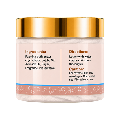 A jar of foaming bath butter with a shiny gold lid and a pale pink label showing ingredients and directions, set against a plain white background.