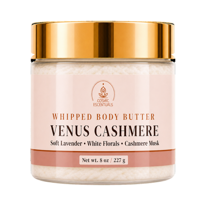 A jar of Venus Cashmere Whipped Body Butter by Cosmic Essentials, featuring a soft pink label and a metallic gold lid, set against a plain white background.