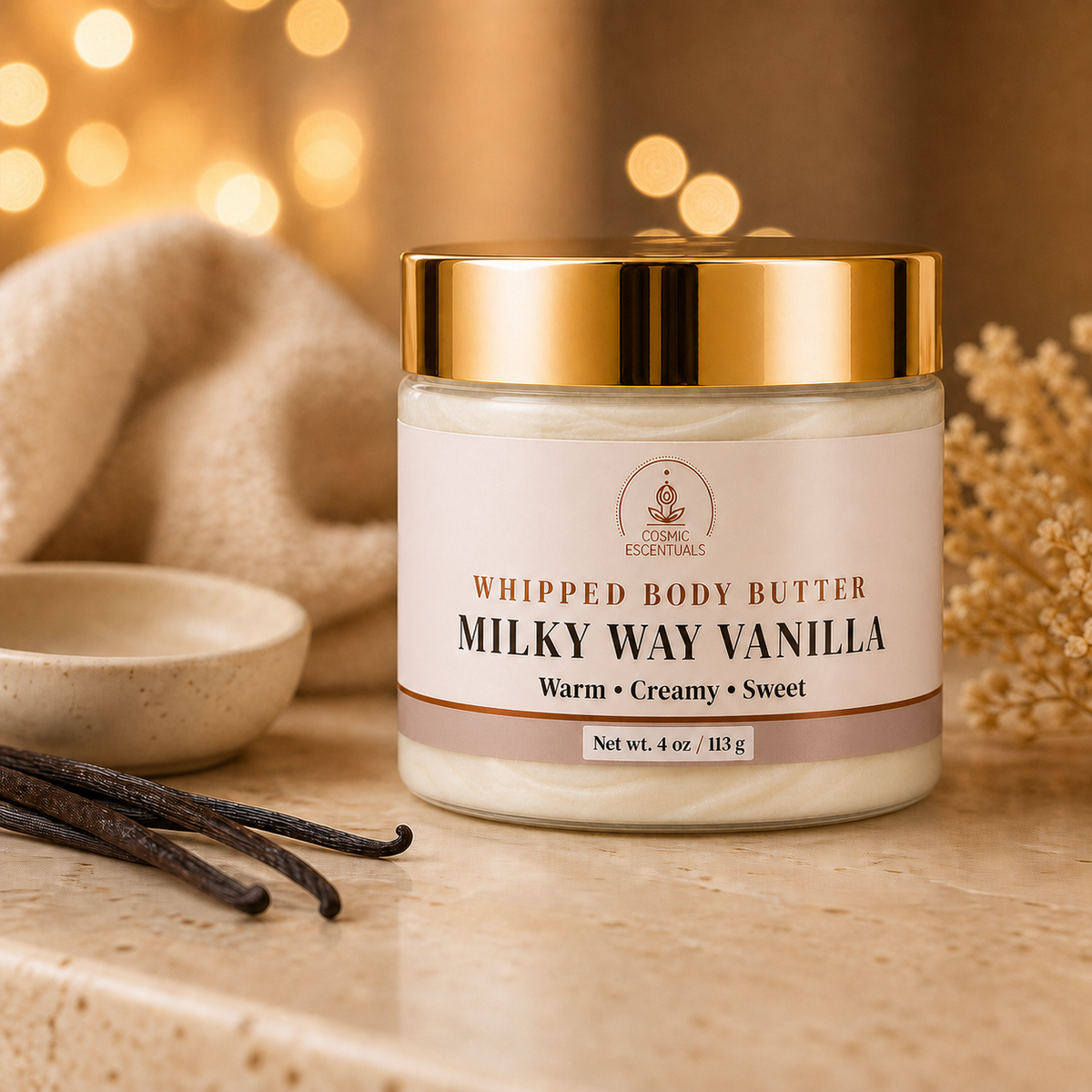 Milky Way Vanilla Whipped Body Butter styled with vanilla beans, warm towels, and spa accessories.